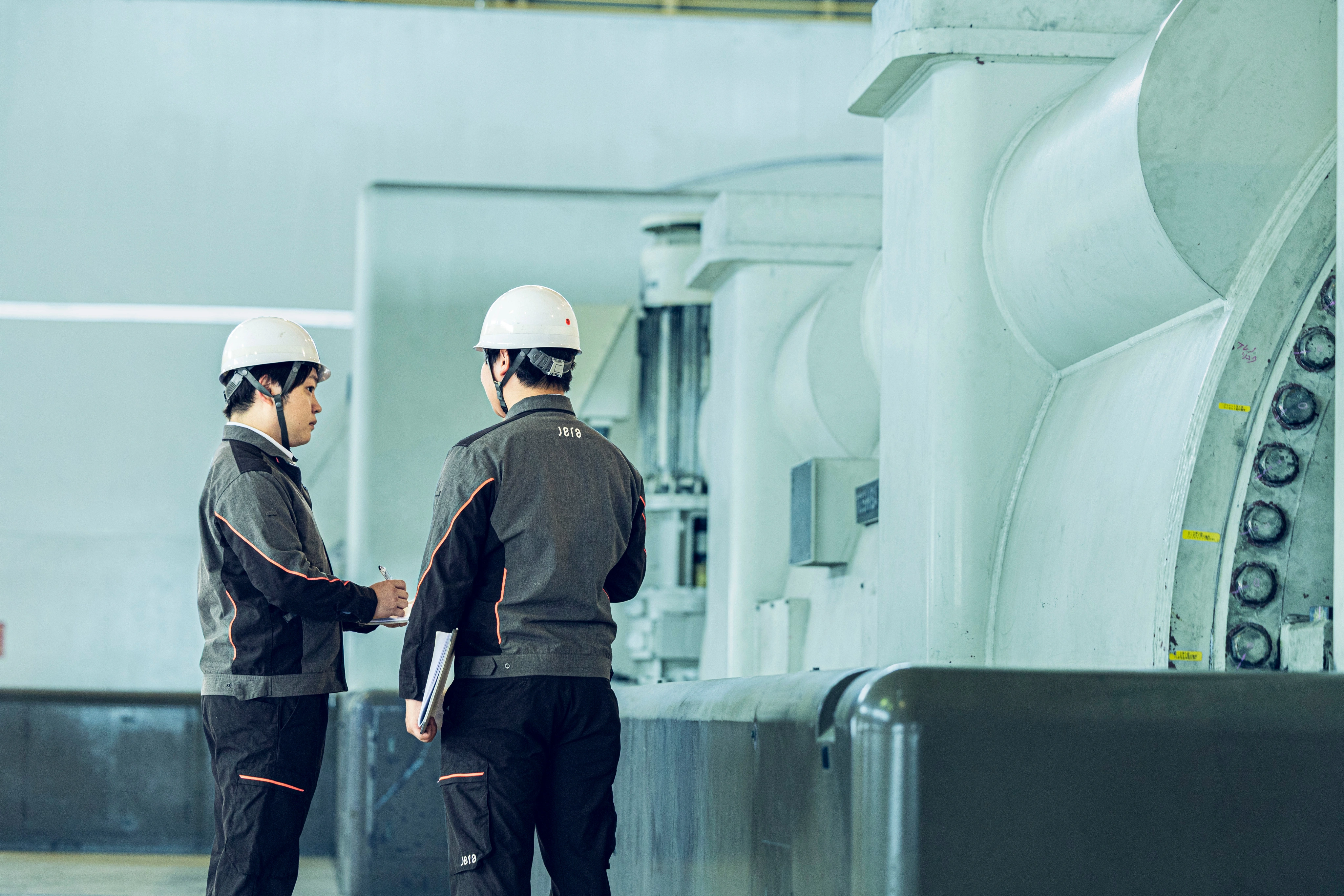 Engineers inspecting turbine equipment in a power plant